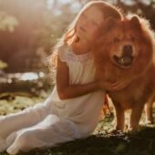 A small petting her dog